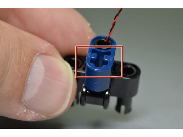 Carefully re-attach the small blue Technic beam to the black mount, taking care to make sure the Pico LED is aligned with the open hole in the blue mount (red arrow, second photo) and facing backward (blue arrow, second photo).