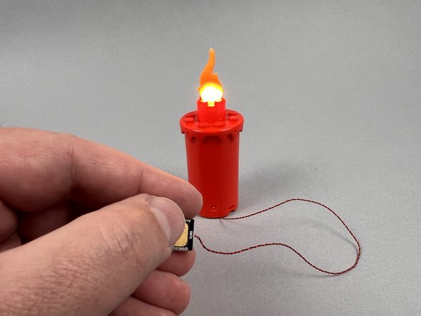 As shown in the second photo, your candle flame should turn on and begin flickering.