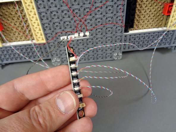 As shown in the photos for this step, connect the four color-changing spotlights to plugs 1-4 on the BRANCH17 adapter board.