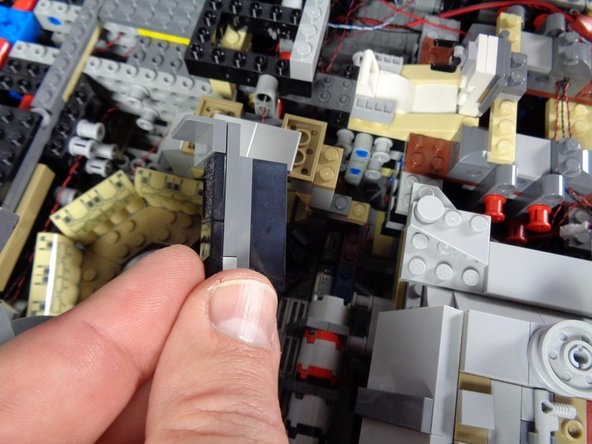 As shown in the second and third photos, carefully remove the pieces holding the computer in place.