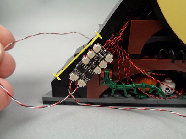 As shown by the yellow line in the third photo for this step, you should mount the board on an angle so its OUTPUT plug is easily accessible.  This will make it easier to connect or disconnect the other modules if you need to transport your LEGO set.