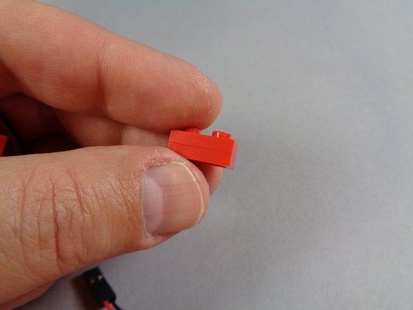 As shown in the third photo for this step, connect the two red 1x2 LEGO plates together.