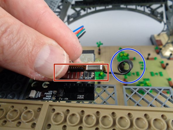 As shown in the second photo, carefully press the pins on the bottom side of the receiver board into the black connector on the top of the controller board.