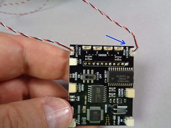 Beginning with the shorter wire (front lightbar) carefully connect this wire to the top-facing plug labeled &quot;FRONT LIGHTBAR&quot; on the main controller board as shown in the second photo.