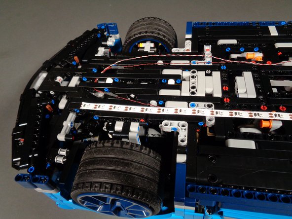 Make sure the strip is straight, and press firmly to attach to the underside of the frame.