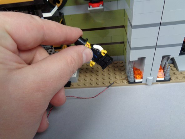 If your minifigure greeter is standing behind the desk, remove him as well (as shown in the second photo).