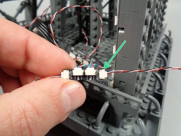 Take another 3-wire control cable, and as shown by the green arrow in the first photo for this step, connect one end of it to the OUTPUT plug on the adapter board for the pair of light strips you just finished mounting.