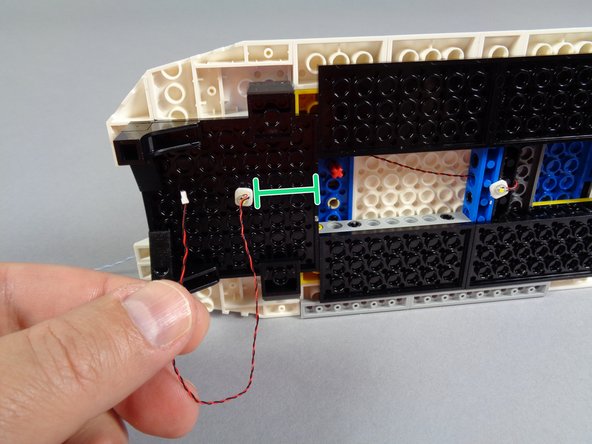 Attach the rear interior light as shown in the first photo for this step.