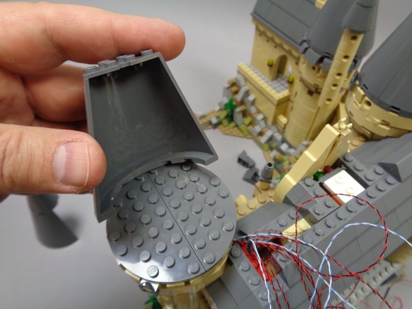 As shown in the third photo, re-attach the front cone section on top of the tower.
