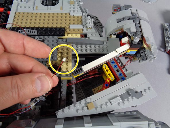 If  you used the extra cool white Pico LED light that came with your old Falcon kit to attach to the interior of the cockpit, disconnect that light from the BRANCH15 adapter board as shown by the yellow circle in the first photo.