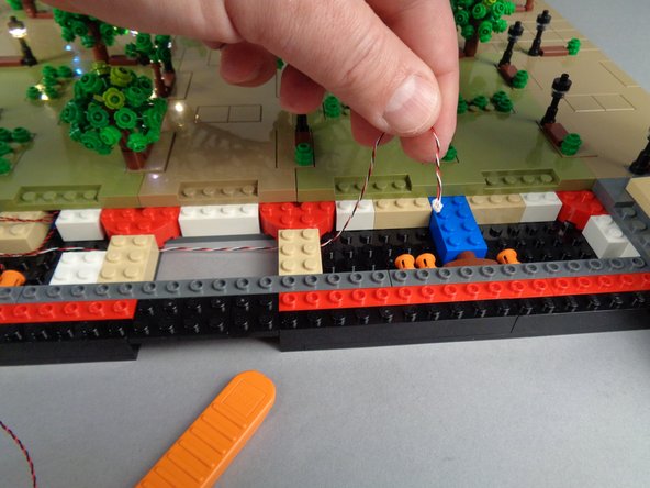 As shown in the third photo, you should now have the control cable passing from Section 1 (the lamp posts you have already connected) over to Section 2 (where you will work next).