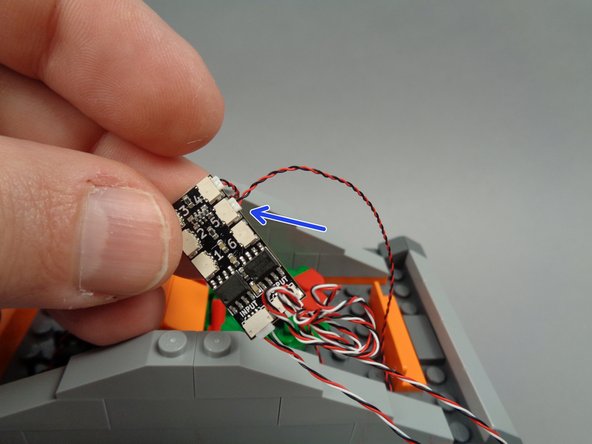 As shown by the arrow in the second photo for this step, connect the right torch wire to plug #5 on the BRANCH06X driver board.