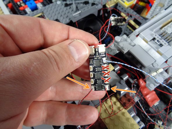 As shown by the two orange arrows, connect the wires for the computer lights to plugs #5 and #6 on the third BRANCH09X adapter board.