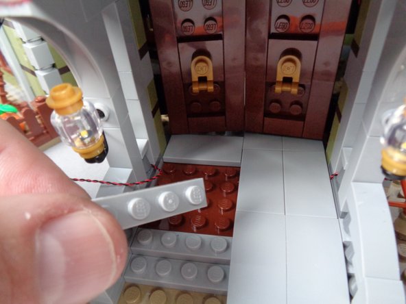 As shown in the first two photos for this step, disassemble the top layer of the left side of the front porch floor.