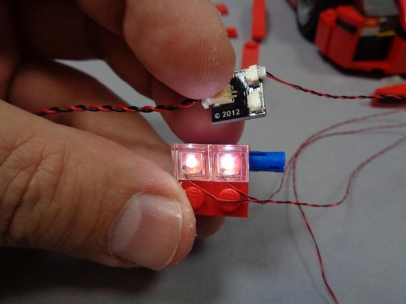 Using the included USB cable and BRANCH03 adapter board, test the headlight assembly you completed in the previous step.  Both headlights should light up.