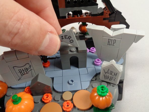 As shown in the photos for this step, remove the roof and center section of the grave.