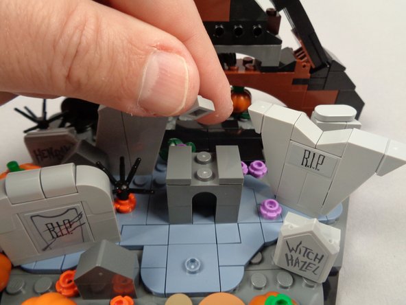 As shown in the photos for this step, remove the roof and center section of the grave.