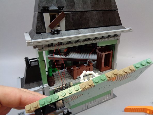 Once you have loosened the bricks along the top of the bedroom wall, you should be able to tilt the wall out and remove it in a single piece as shown in the first photo.