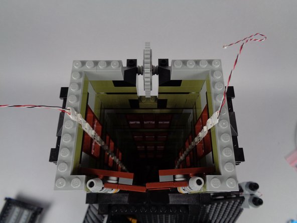 Repeat the same process for the second light strip on the opposite side of the tower wall.  Both strips should now be firmly attached to the inner wall, and both should run in a straight line up the length of the tower.