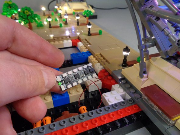 As shown in the photo for this step, connect the two lamp posts on Panel 4L to any two plugs on the BRANCH12X driver board, and verify that both lamp posts light up.