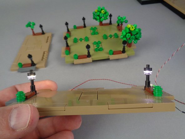 The photos for this step show only two lamp posts being connected and tested, but you will have four lamp posts in your Panel 1F section to connect and test.