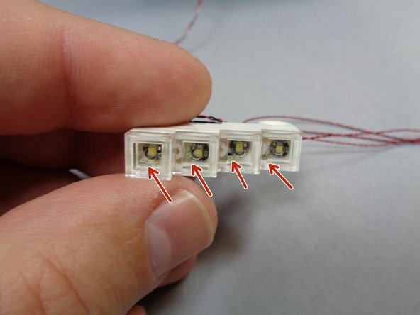 The headlight assembly is very fragile.  Do not pull on any wires, as doing so may damage the LEDs inside the assembly.