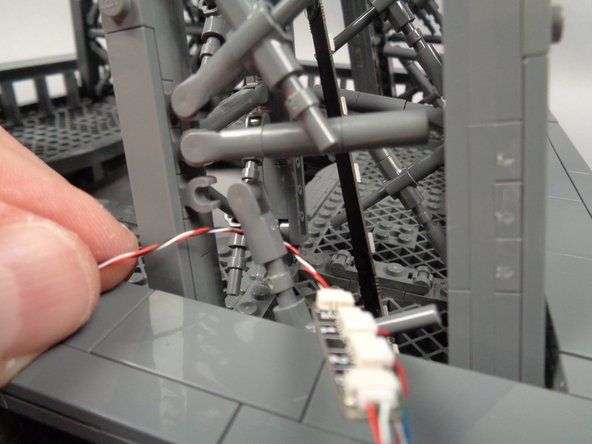 As shown in the second photo, pass the incoming control cable BEHIND the "X" crossbar.