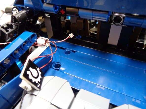 As shown in the first two photos, route the 3-wire headlight control cable into the same area as the main controller board.