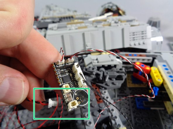 As shown by the yellow arrow in the second photo, connect the power wire to one of the three plugs on the new TRUNK08 controller labeled &quot;POWER.&quot;