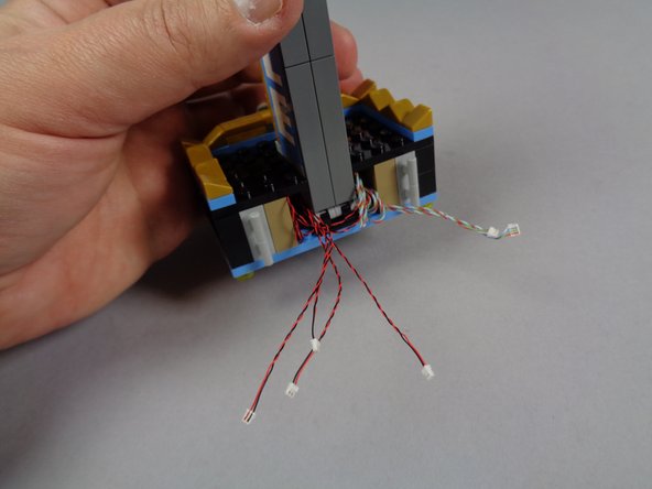 The third photo shows the two top side plates re-attached, and the shorter wires exiting out the back of the marquee.