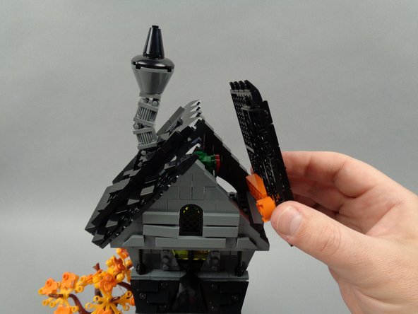 As shown in the photos for this step, re-attach the two roof sections of Jack's house.