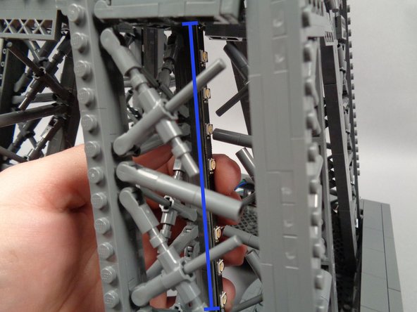 As shown in the second photo, mount the light strip to the rear inside of the pillar, pressing with two fingers to make sure it adheres firmly to the tower frame.