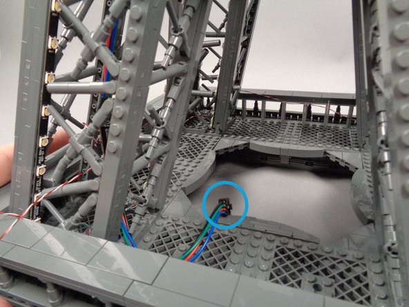 When you are done feeding the male plug, it should hang over the inner edge of the center Tower section as shown by the blue circle in the third photo.