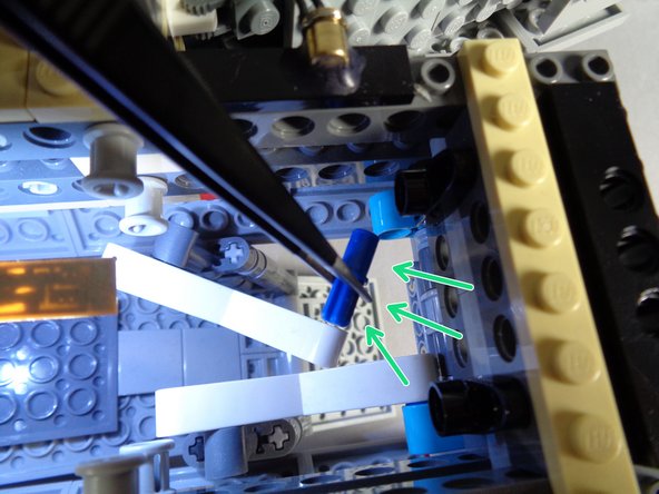 As shown by the red circle in the first photo, remove the first arm from its mount.