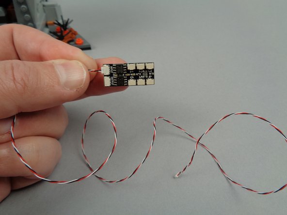 As shown in the second photo for this step, connect one end of the 3-wire connecting cable to the INPUT plug on the BRANCH06X driver board.