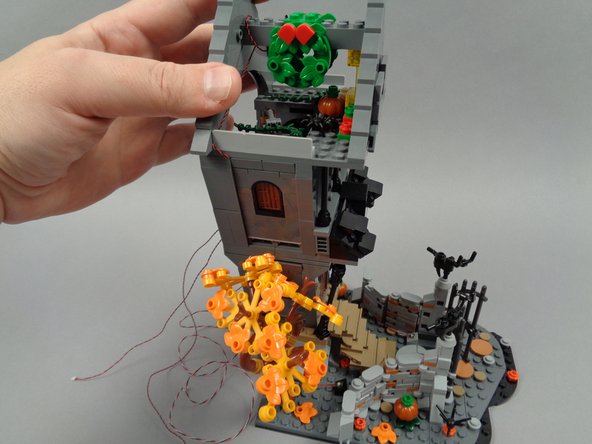 Re-attach the second floor to the house as shown in the second photo for this step.