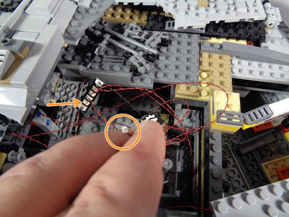 As shown in the first photo for this step, carefully remove the top panels in front of the boarding ramp, and set aside.