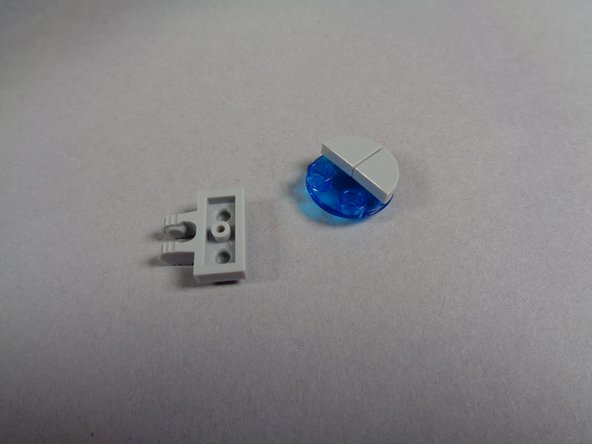 As shown in the second and third photos for this step, disassemble the hood spot light and detach it from its clip.