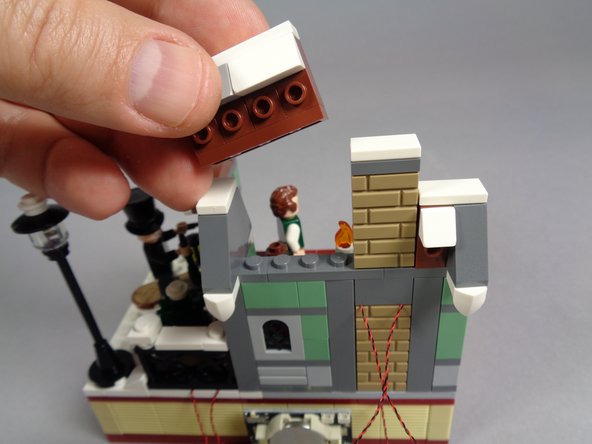 As shown by the first and second photo, re-attach the other main wall section, then finish re-attaching the remaining parts of the wall and roof.