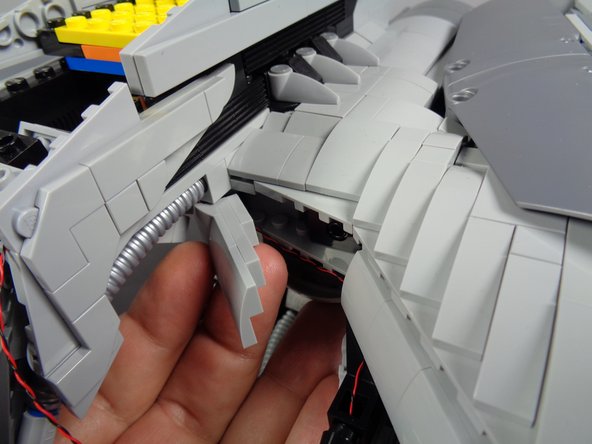 As shown in the second photo, re-attach the armor section you removed in the last step.