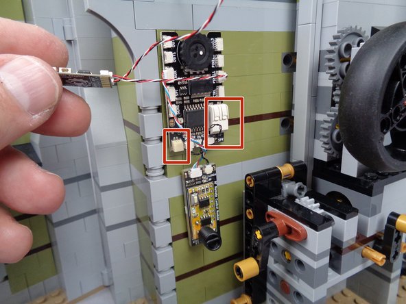 As shown in the photo for this step, next you can attach the remote receive board just below the main effect controller.  The wires connecting the receiver board are short, but they will allow attaching the receiver a short distance below the main effect controller as shown in the photo.