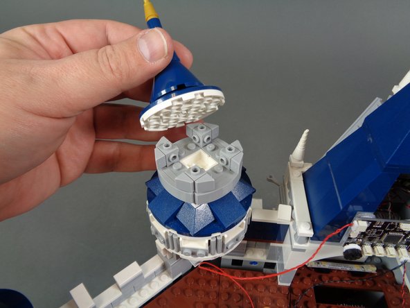 As shown in the photos for this step, remove the top and rear parts from the second tower so you can mount the second LED light.