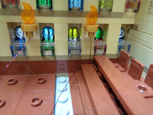 As shown in the first photo, re-attach the LEGO® plate on top of the first torch light wire.