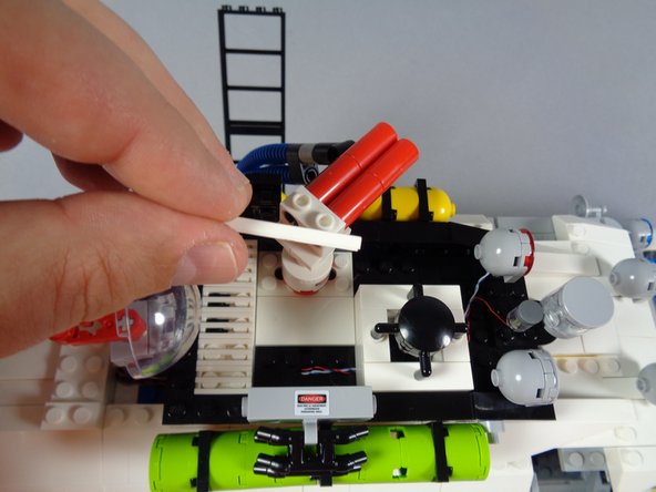 If, like us when we took the photos for this installation guide, you forgot to re-attach the white 2x4 tile on the roof, you can do that now, as shown in the first photo for this step.