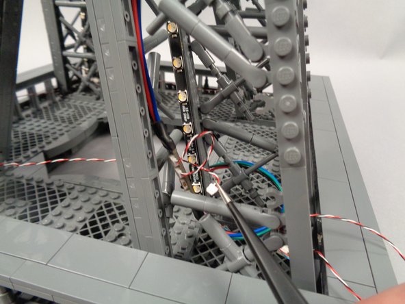 As shown in the first photo for this step, pull the end of the control cable from the 4th adapter board toward the inter-level connecting board.