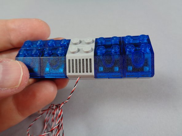 As shown in the third photo for this step, gently press down on the 2x2 slope to secure it in place.