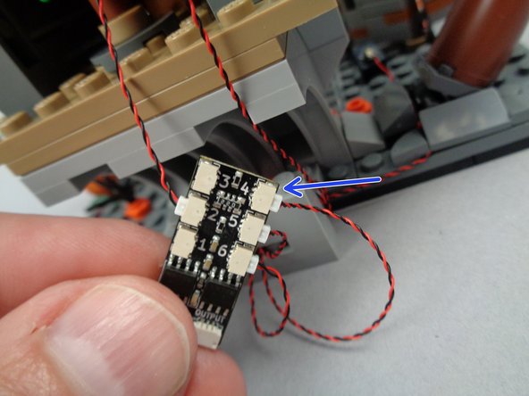 The second photo shows the light bluish gray 1x4 brick removed from the top of the wire base-- this makes it easier to wrap the wire.