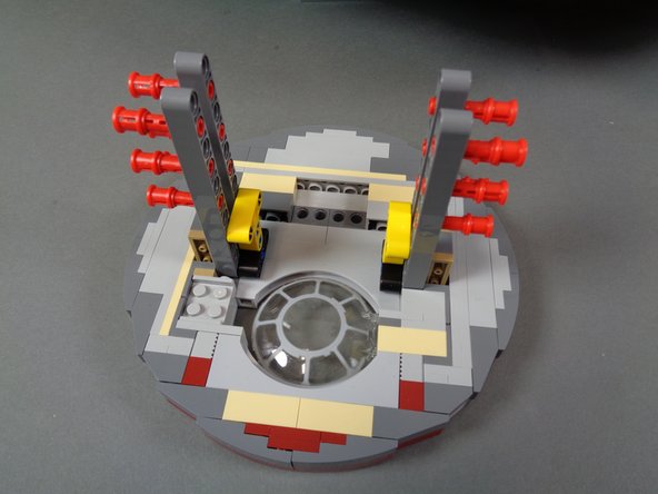 Complete these steps carefully.  You may need to gently lift your Falcon to allow removal of the laser mount.  It maybe easier to ask someone to help lift your Falcon while you gently remove the mount.