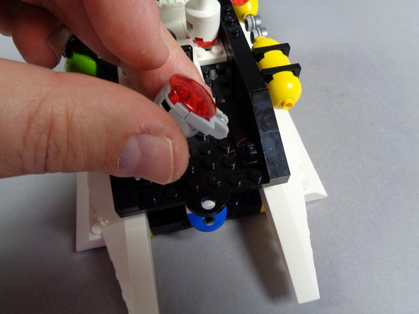 Next, you will mount the large red LED light inside the red roof beacon.