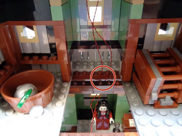 As shown in the first photo, pass the two ultraviolet light wires down through the hole in the attic floor.